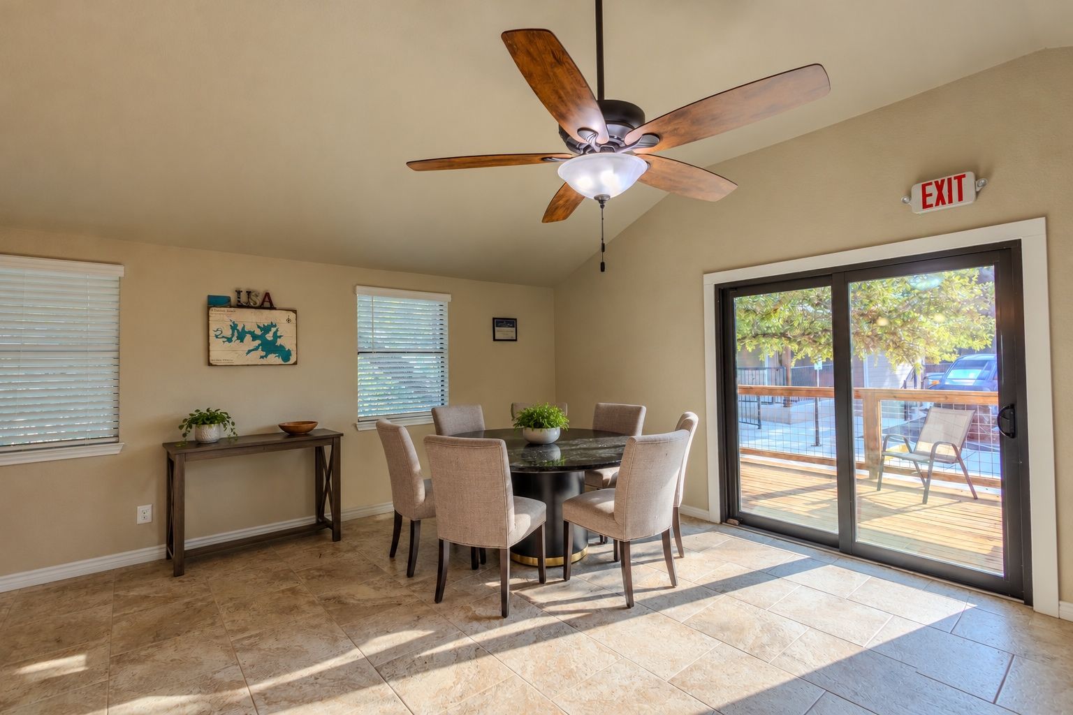 Clubhouse dining room with a round table and sliding doors to the deck