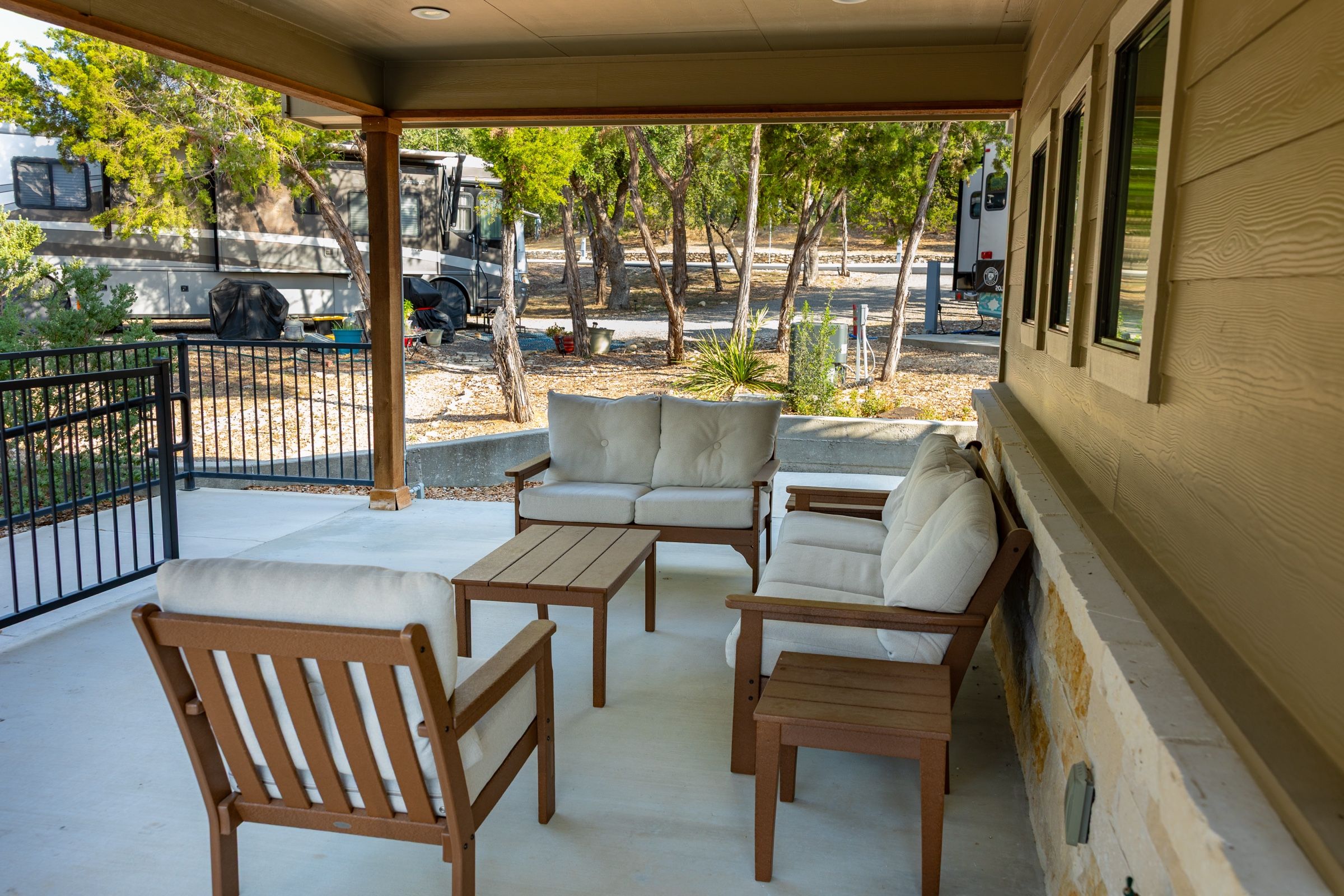 Covered clubhouse porch with outdoor sofa and chairs