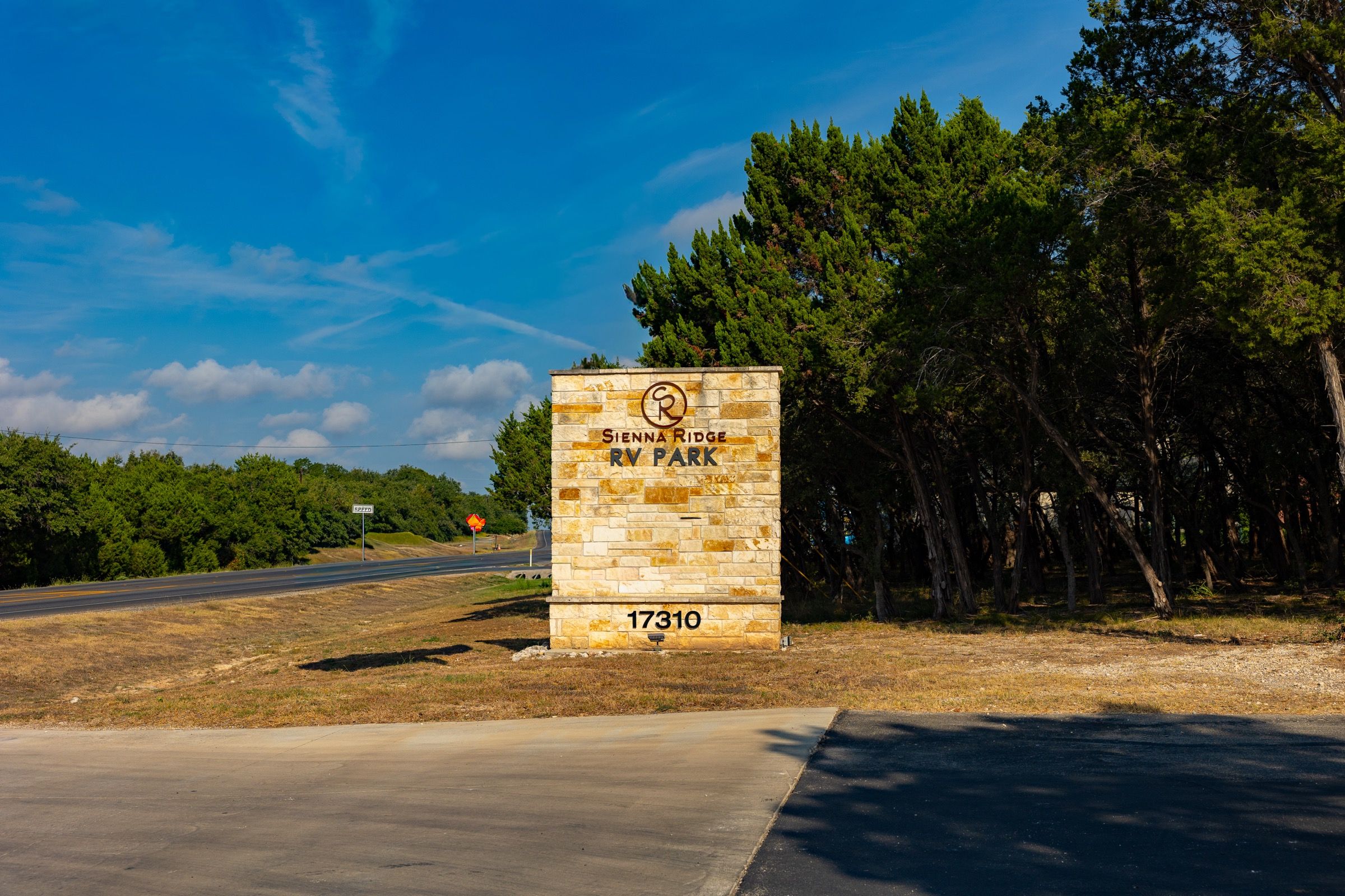 Limestone entrance sign for Sienna Ridge RV Park on FM 306