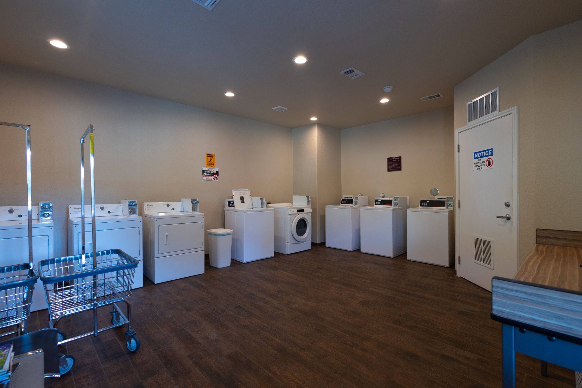Laundry room with rows of washers and dryers
